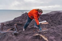 An archaeologist uncovers stamp mill workings along the Lake Superior shore outside Gay, Mich. (Photo courtesy of Neal Harri.)