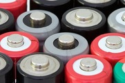 The tops of a group of multi-colored batteries.