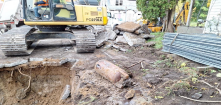 An excavator removes contaminated soil from a former gas station site. 