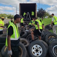 People picking up tires at Battle Creek scrap tire cleanup in 2023. Courtesy of City of Battle Creek.