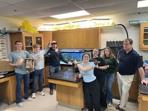 Yale High School students with teacher in front of winning Environmental Service Award project.