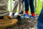 A group of 5th graders clean their shoes on a boot brush after a visit to Maybury State Park.