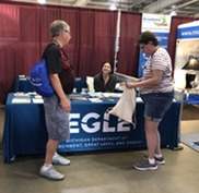 Visitors stop by the EGLE booth at the Upper Peninsula State Fair in 2023.