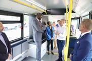 Lt. Governor Garlin Gilchrist stands inside an electric transit bus at a National Parks Service Mobility Challenge event.