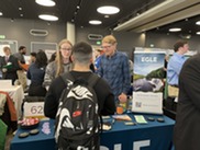 EGLE staffers Thomas Miller and James Dykstra talk to a student at the Western Michigan University's Engineering Career Fair in February 2024.