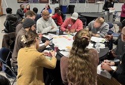 People working around a table discussing climate and environmental justice