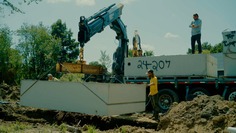 Contractor installing a two compartment, concrete, septic tank. Courtesy Michigan Saves.