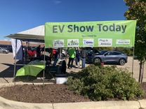 Electric vehicle ride-and-drive event booth in East Lansing in 2022, part of National Drive Electric Week.