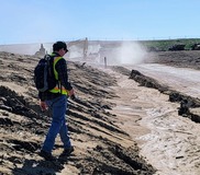 EGLE staffer uses handheld monitor during landfill inspection.