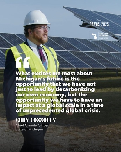 EGLE's Chief Climate Officer walking along solar panels. 