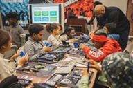Students at a laptop refurbishment training workshop at the 2024 Hendricks Foundation Tech Camp.