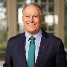 Jay Inslee, a man in a suit, smiling for the camera
