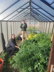 students grow produce in greenhouse