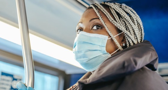 Bus rider inside coach wearing a mask