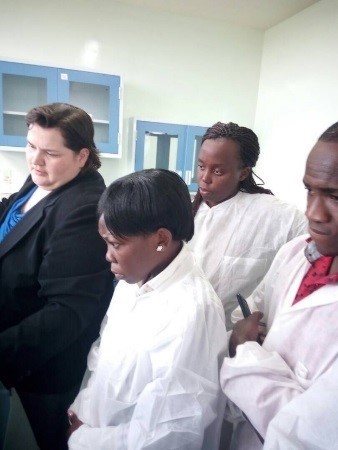 Dr. Soehnlen (left), demonstrates real-time PCR thermocycler programming to members of the Ugandan CPHL.