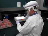 Scientist Working in BSL-3 Environment
