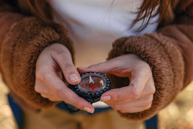 woman holding a compass