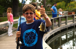 boy holding a fish at the UP State Fair