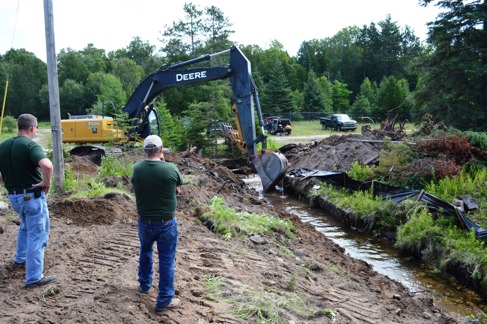 Workers shape the channel in the upper section of the Williams Creek stream rehabilitation project.