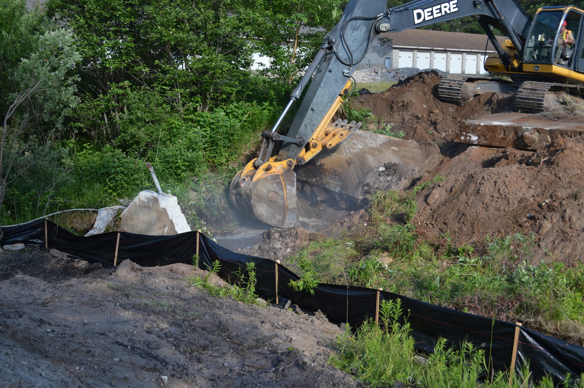 A backhoe works to remove portions of the Williams Creek Dam in summer 2015.