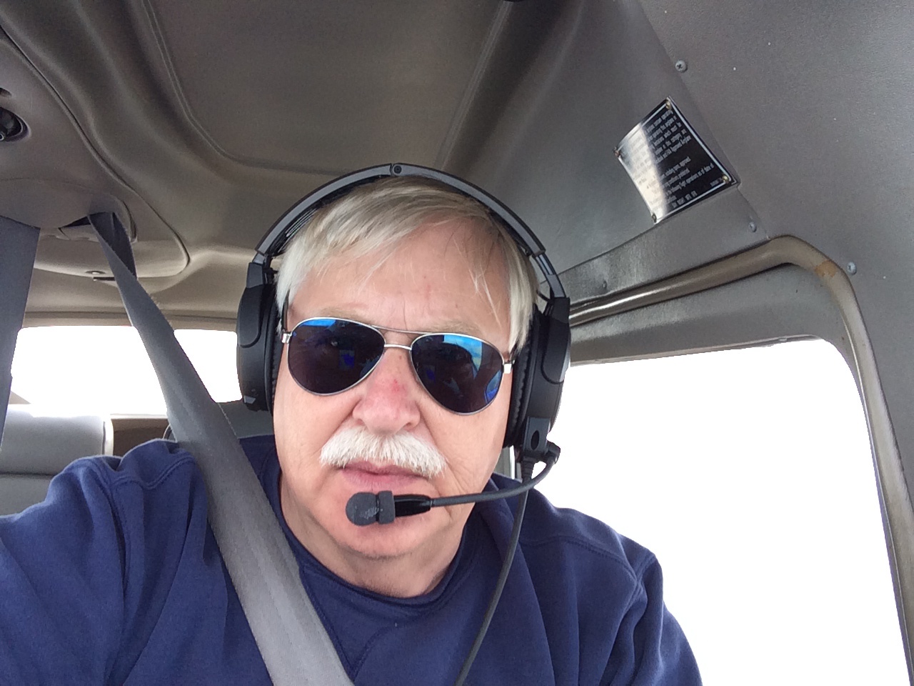 Michigan Department of Natural Resources pilot Neil Harri in the cockpit of his plane.