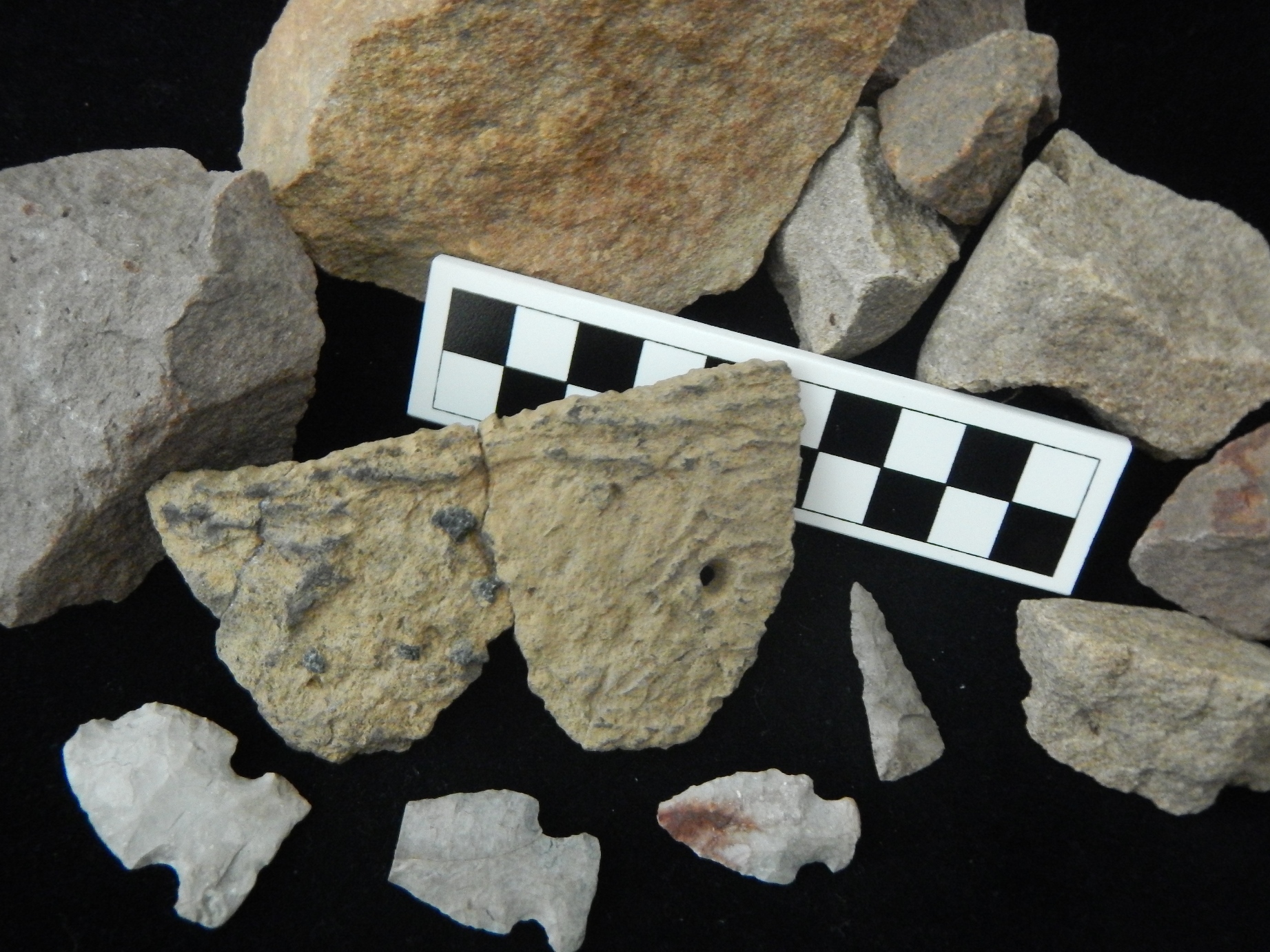 Artifacts recovered at the Sanilac Petroglyphs Historic State Park, including fire-cracked rock from hearths, refitted pieces of decorated pottery and
