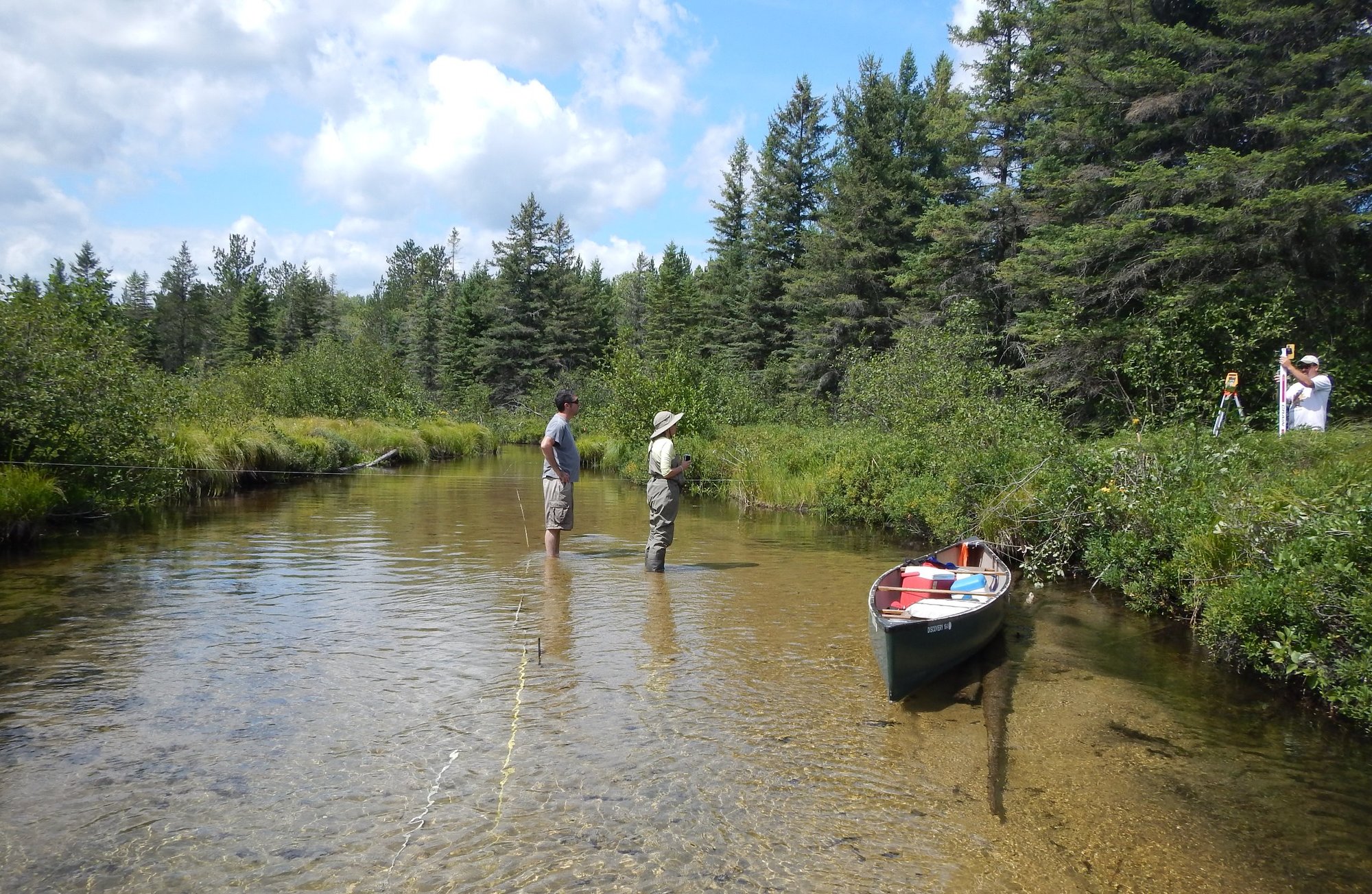 Stream workers measure a riffle cross-section on Canada Creek in Montmorency County
