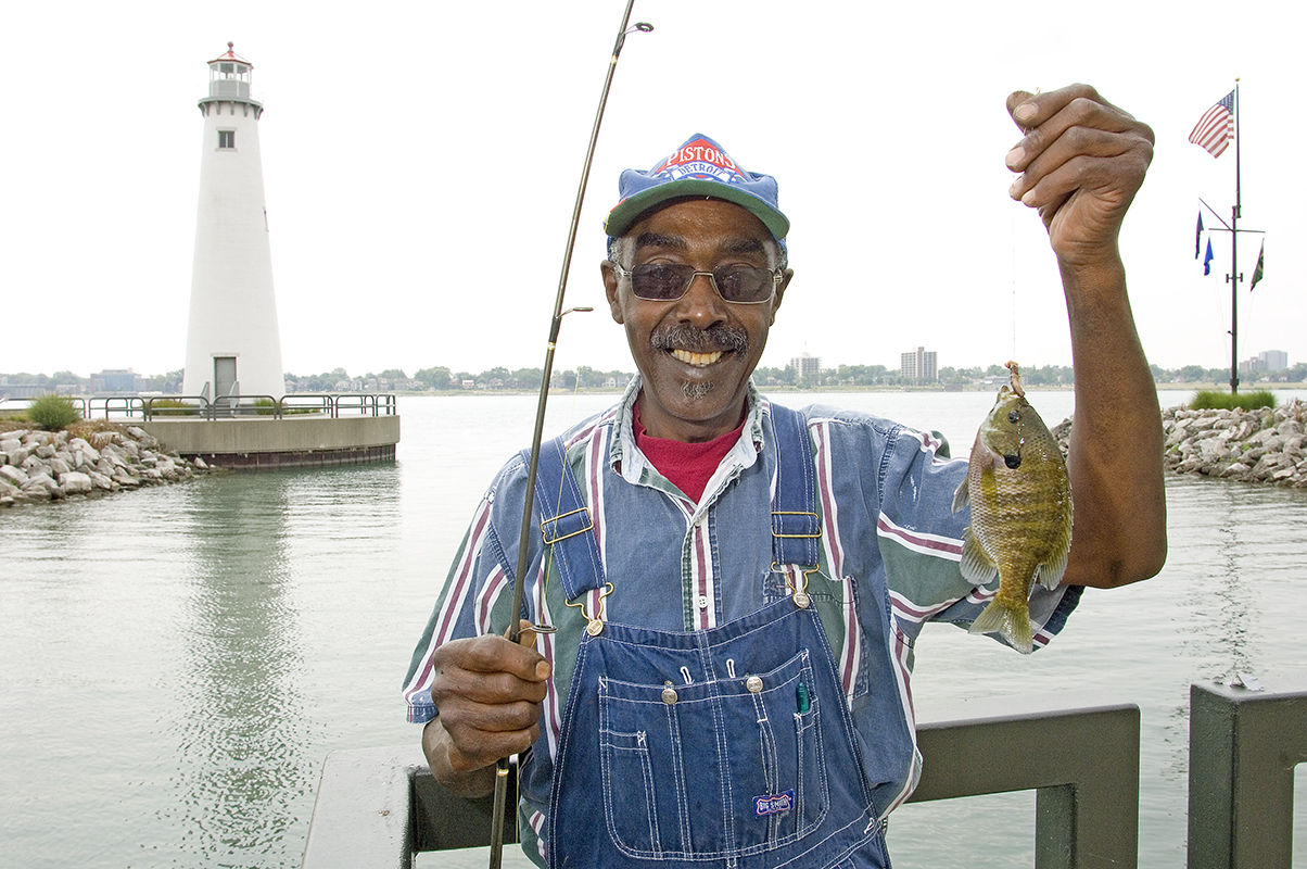 A happy angler shows his catch at the William G. Milliken State Park and Harbor.