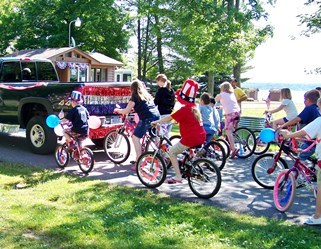 Kids riding their bikes through Fourth of July parade