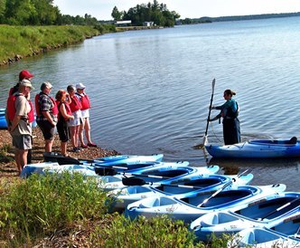 An instructor teaching the basics of kayaking at Baraga.
