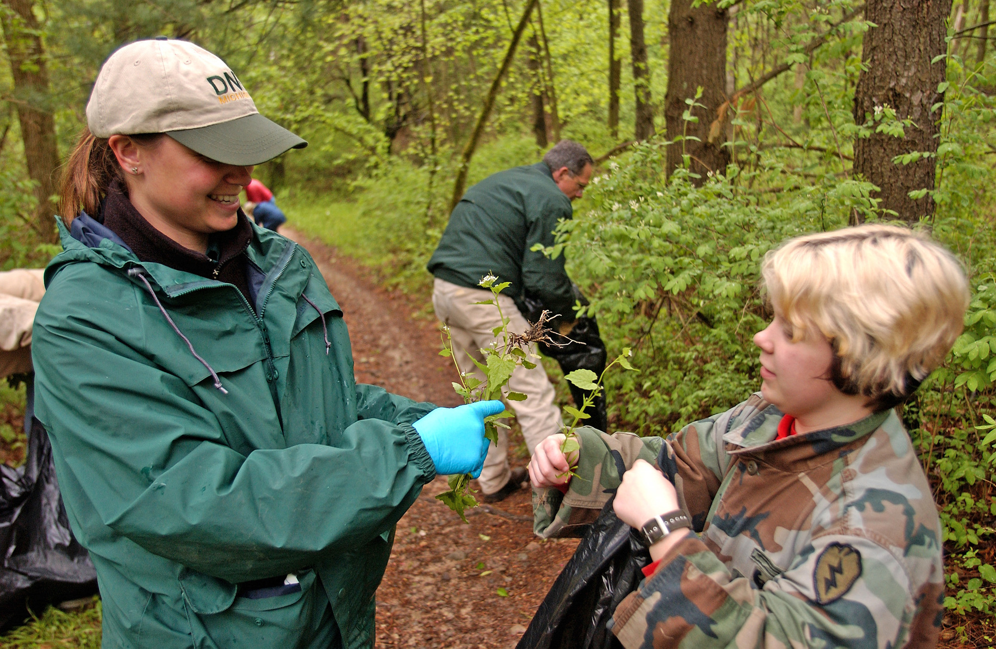 Volunteers engaged in invasive plant removal at the Bald Mountain Recreation Area, near Lake Orion, Michigan.