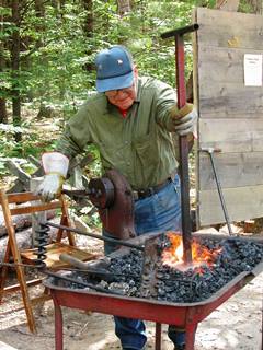 Blacksmith holding iron in hot coals