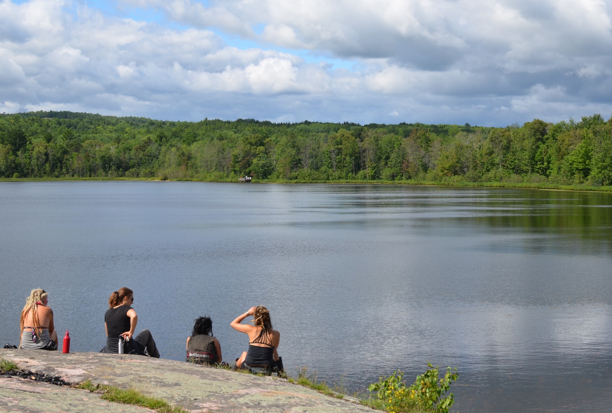 Visitors to Little Presque Isle enjoy the view from a rocky bluff overlooking Harlow Lake in Marquette County.