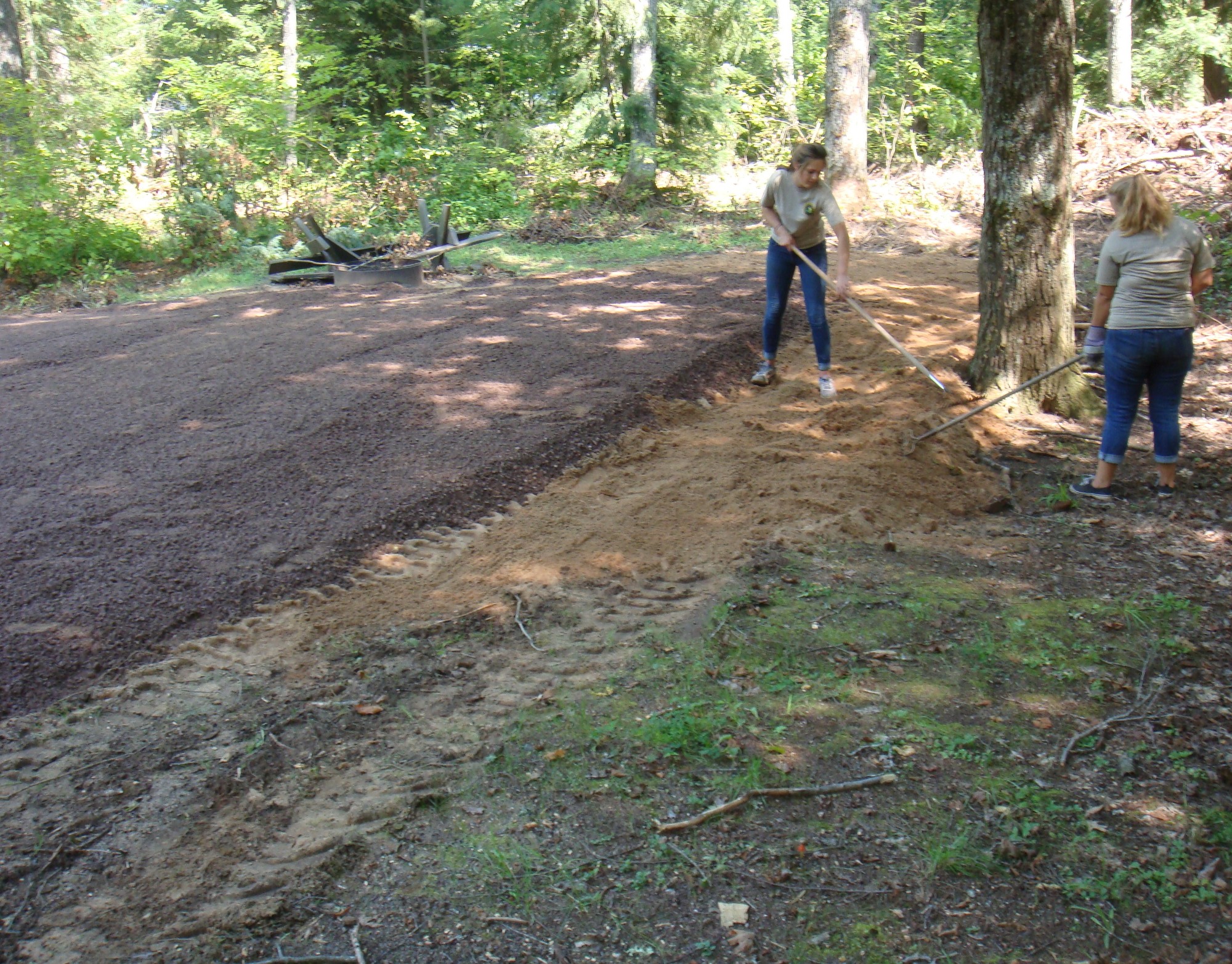 Michigan Department of Natural Resources staff works on continuing repairs from July storm damage at the Emily Lake State Forest Campground.