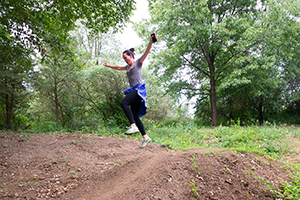 Woman jumping on trail