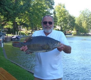 Older man holding a smallmouth bass