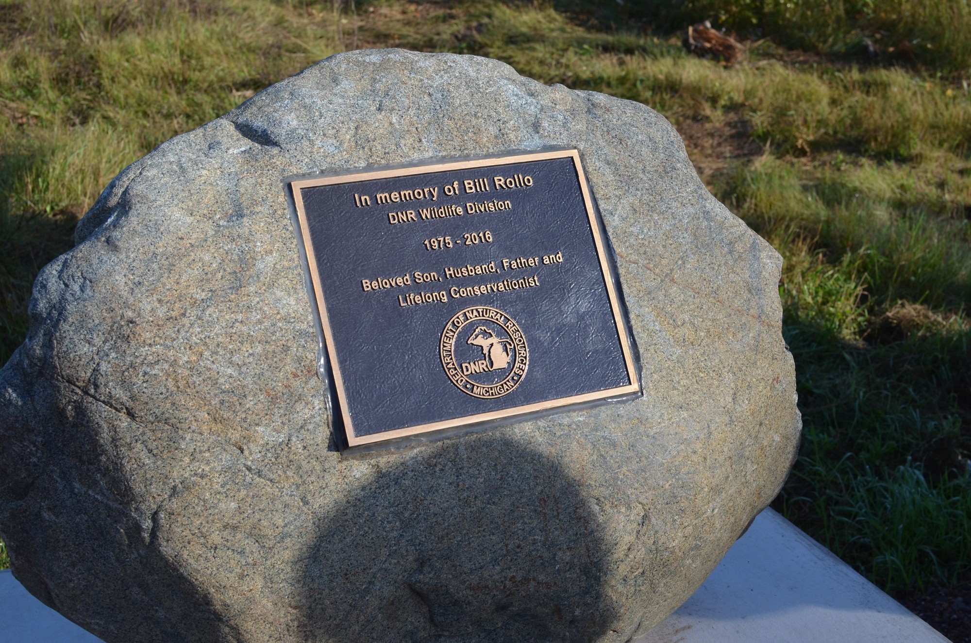 The memorial stone for Bill Rollo at the Michigan Department of Natural Resources Grouse Enhanced Management Site in south Marquette County. 