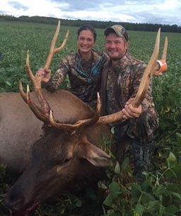 Female hunter with harvested 5x5 elk and hunter's boyfriend