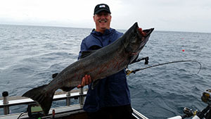 Angler holding a Chinook salmon