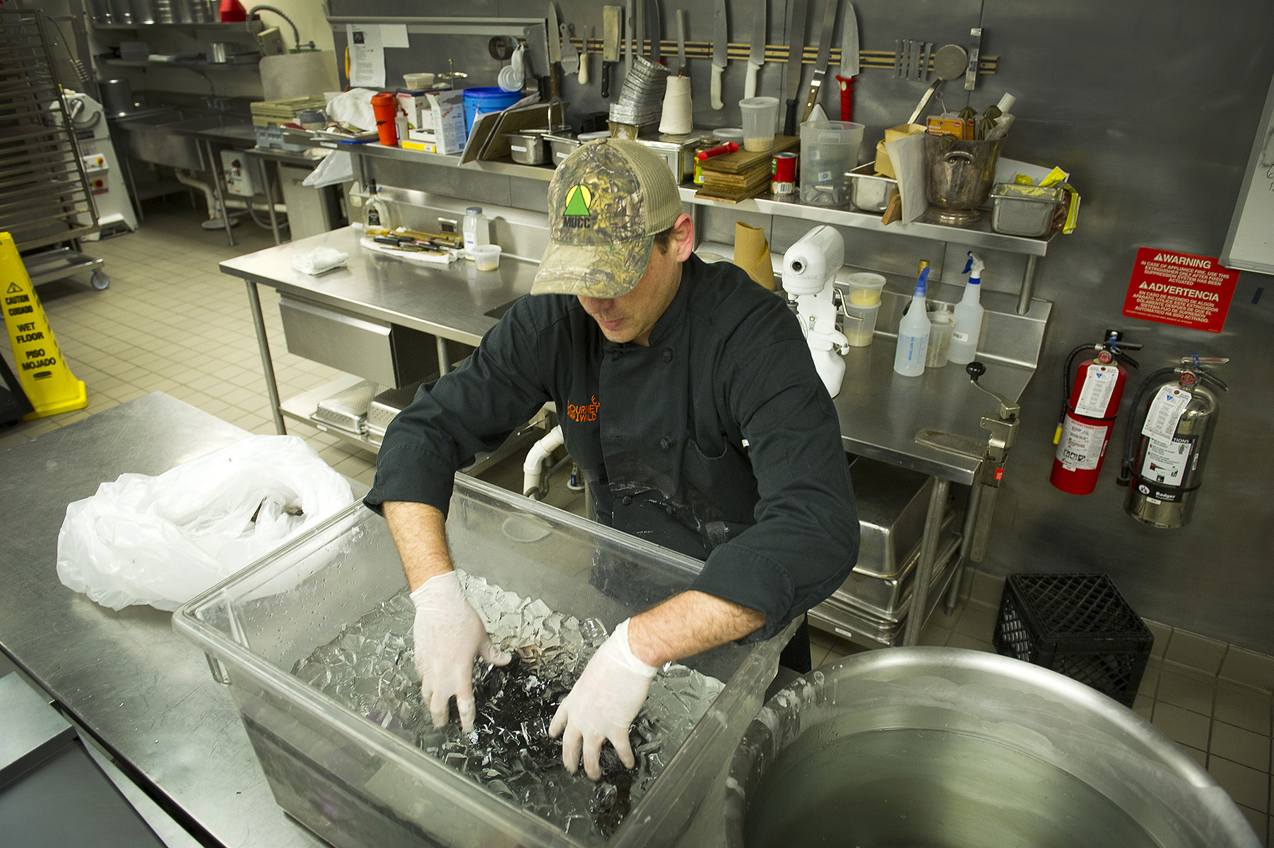 Gourmet Gone Wild executive chef Dan Nelson immerses a wild turkey in an ice bath. The wax will congeal on the feathers, making it easier to pluck.