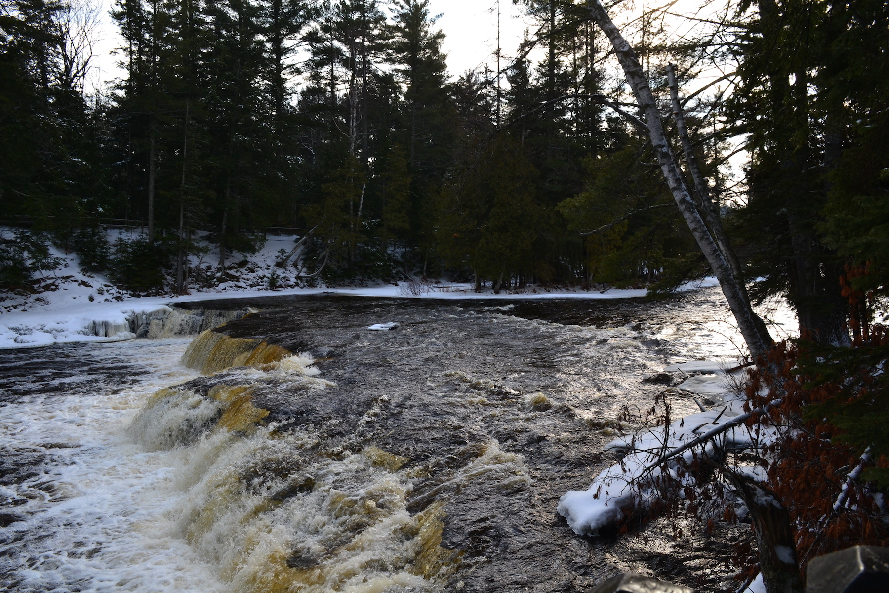 A winter scene at the Lower Falls is shown from Tahquamenon Falls State Park.