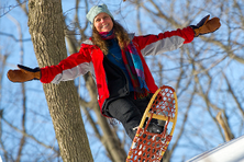 visitor holding up snowshoes