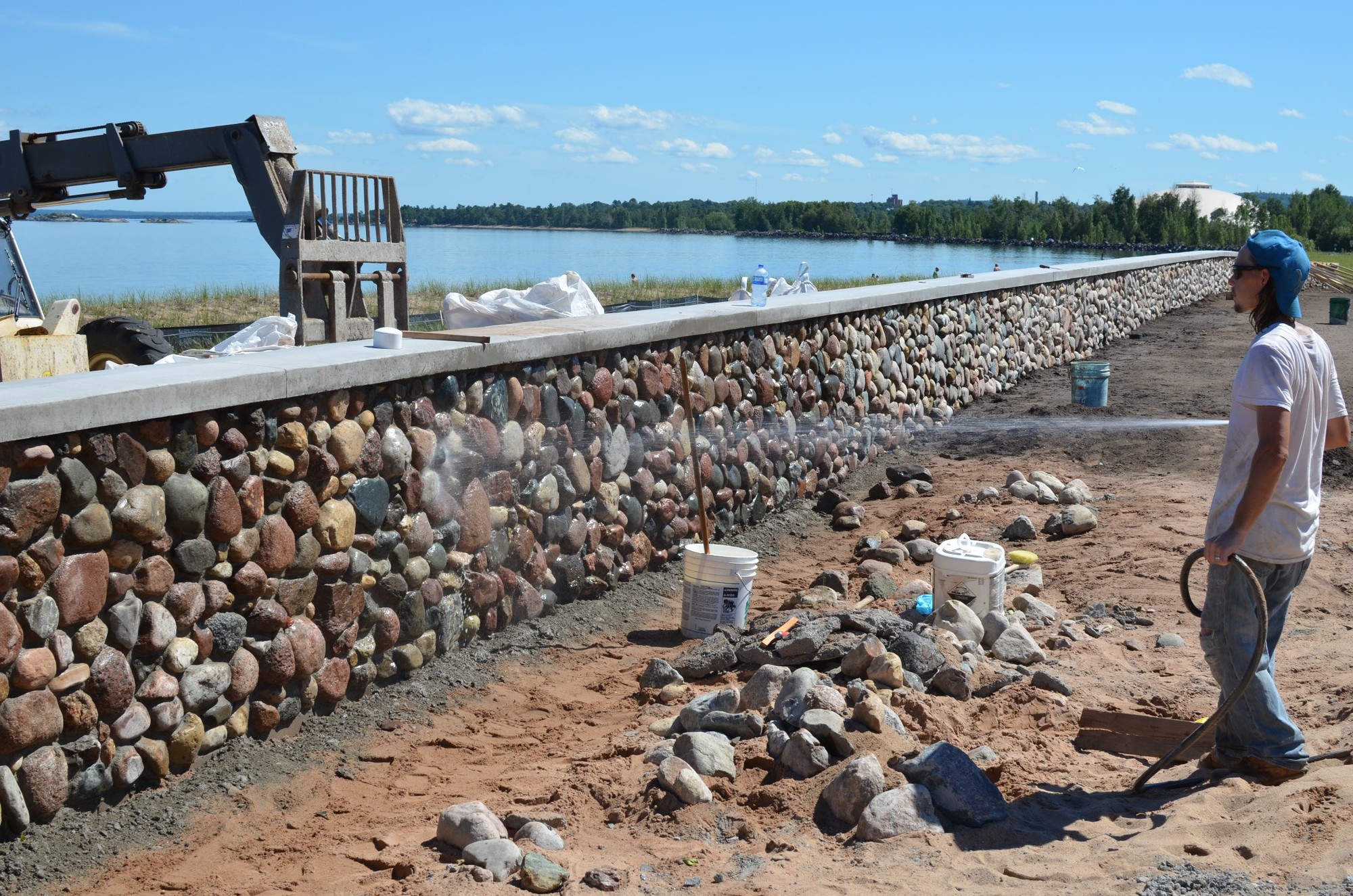 Workers building a decorative wall at Clark Lambros Beach Park in Marquette County this past summer.