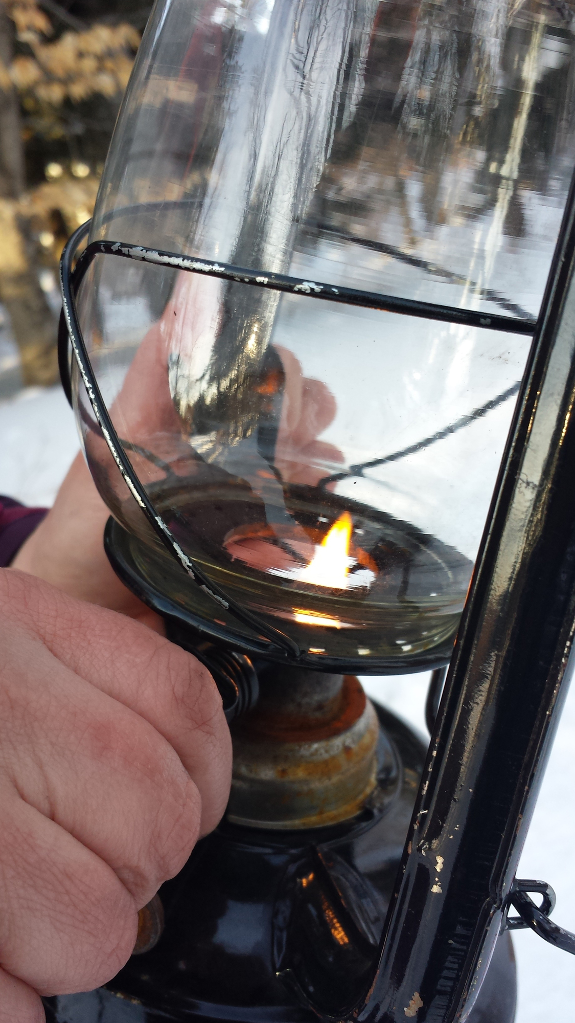 A trail lantern being lit at Tahquamenon Falls State Park in Luce County.
