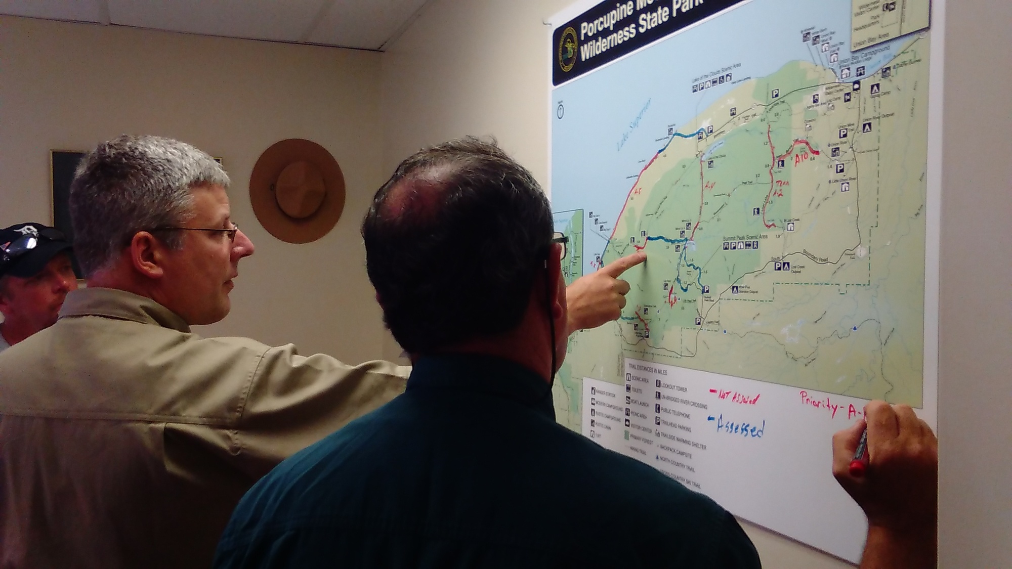 Members of the incident command team look over a progress map at Porcupine Mountains Wilderness State Park.