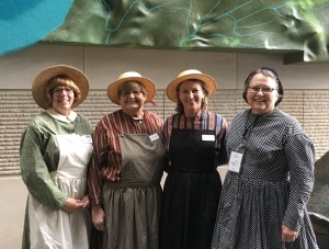 four female docents dressed in period costume