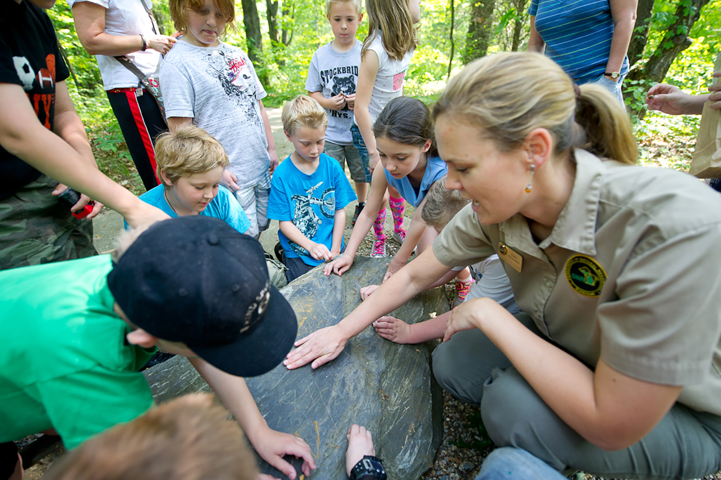 Participants in a nature education program at Eddy Discovery Center, located in Waterloo Recreation Area near Chelsea, learn about geology.