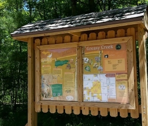 Wood-framed informational kiosk at GEMS location