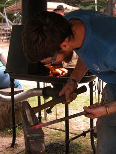 closeup view of blacksmith molding hot iron