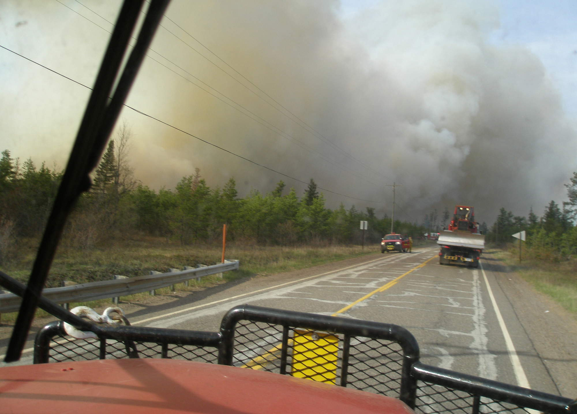 A fire crew heads down Marquette County Road 581 toward the Black River Falls Fire.